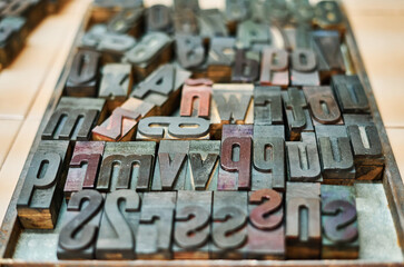 Collection of metal letters and numbers in wooden box