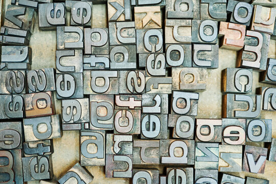 Collection of metal letters in wooden box