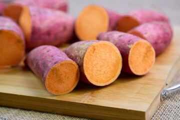 closeup cut of raw sweet potato on cutting board
