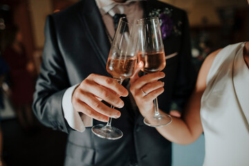 Loving newlyweds with glasses with champagne