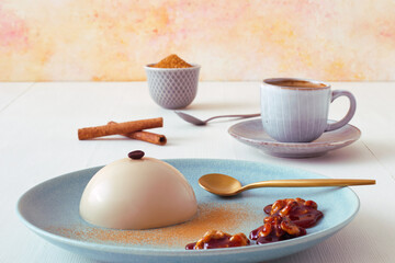 Espresso panna cotta with wallnuts in caramel, cup of coffee and bowl with sugar cane. Flat lay, top down view.
