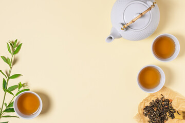 Obraz na płótnie Canvas Asian tea ceremony with teapot and tea cups top view.