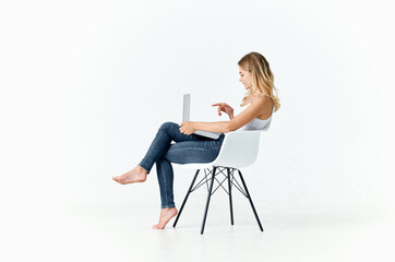 woman sitting on a chair with laptop internet communication online