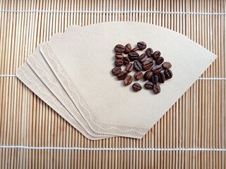 Paper filters and coffee beans. Coffee making, coffee shop.