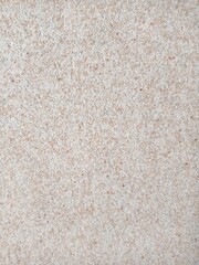 The background is stone. Granite. Beige background. Non-uniform texture. Wallpaper.
