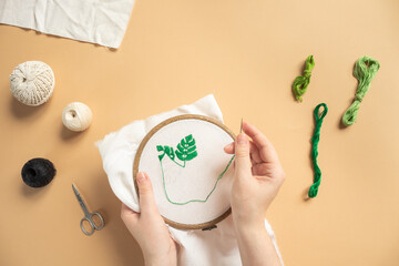 Workshop of embroidery top view. Workshop, needlework and knitting. Female hands with needle and...