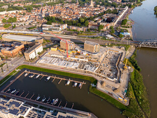 Luxury apartment complex construction site at riverbank of river IJssel with recreational port. Aerial top down blueprint view of the new Kade Zuid project in Noorderhaven residential neighbourhood 