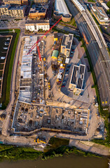 Fototapeta premium Wide panorama of luxury apartment complex construction site at riverbank of river IJssel. Aerial top down blueprint view of the new Kade Zuid project in Noorderhaven residential neighbourhood 