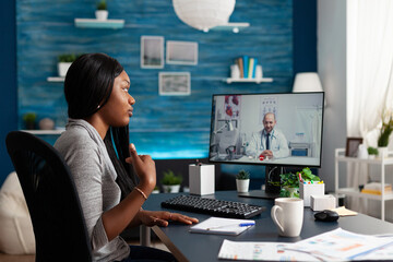 African american student chatting with therapist doctor explaining disease symptoms during online videocall meeting appointment. Physician discussing sickness test result talking healthcare treatment - obrazy, fototapety, plakaty