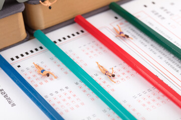 Miniature figures of Chinese college entrance examinations swimming competition on the answer sheet