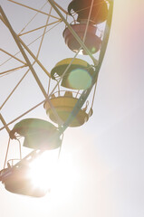 ferries wheel in sunset sun beams at the amusement park