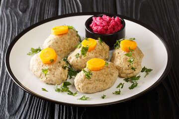 Delicious Jewish Gefilte Fish for Passover with horseradish and carrots close-up in a plate on the table. horizontal. Horizontal