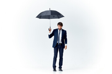 business man in a suit holding an umbrella elegant style protection from the rain