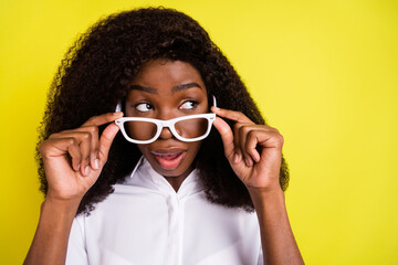 Photo of questioned young student look empty space wear spectacles white shirt isolated on vivid yellow color background