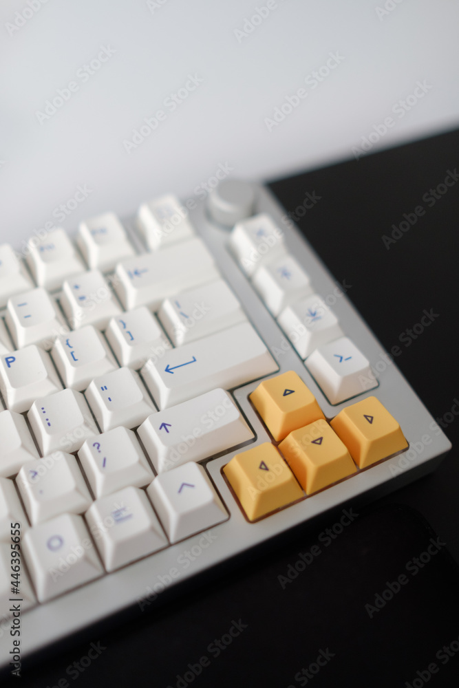 Poster closeup of white and yellow buttons on a mechanical computer keyboard