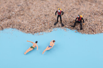 Two divers by the sea watching two swimmers come ashore