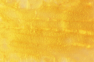 Golden strokes moisturizing mask close-up, texture and background.