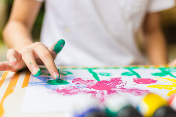 Naklejka premium Kid at the table draw with water color, Cheerful little cute girl playing and learning with coloring the colors
