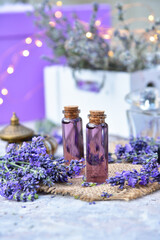 Obraz na płótnie Canvas Lavender oil and lavender flowers on bokeh background.