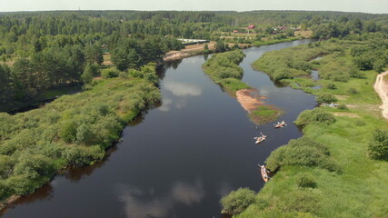 Drone point view of group people kayaker floating on water. Aerial drone view of group kayak in lake. Kayaking and Canoeing along the Riverbed Aerial View. Rafting. Tracking a Boat