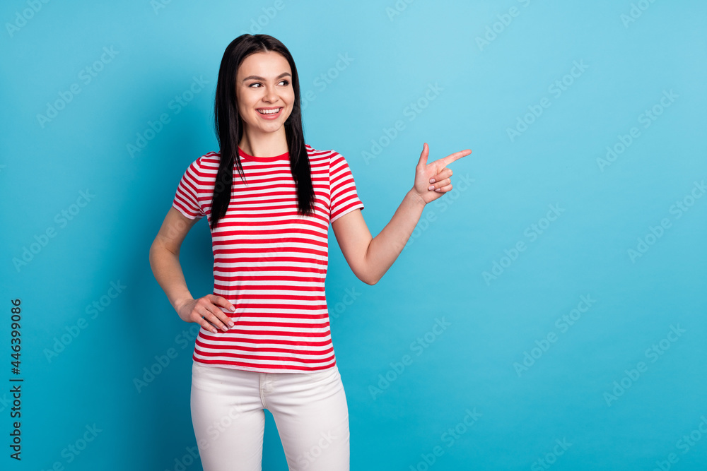 Wall mural photo of happy smiling good mood beautiful girl advertisement point finger copyspace isolated on blu