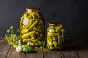 Pickled cucumbers in the jar. Ingredients for pickling cucumbers. Cucumbers, dill, garlic. Glass...