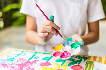 Naklejka premium Kid at the table draw with water color, Cheerful little cute girl playing and learning with coloring the colors