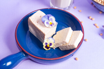 Tofu soy beans and soy milk dairy substitute vegan vegetarian minimalistic copy space negative space pastel purple bacground food style inspiration