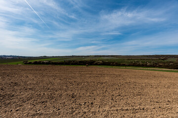 Early springtime countryside with fields, meadows, vineayards, blossoming trees, smaller village...