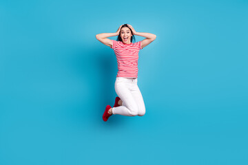 Fototapeta na wymiar Full size profile side photo of young girl happy positive smile amazed shcoked jump up isolated over blue color background