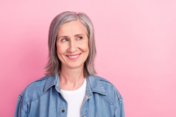 Fototapeta premium Photo of stylish old lady look empty space wear blue jacket isolated on pastel pink color background