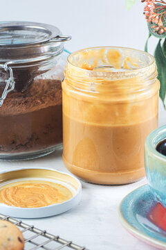glass jars with peanut butter and chocolate powder