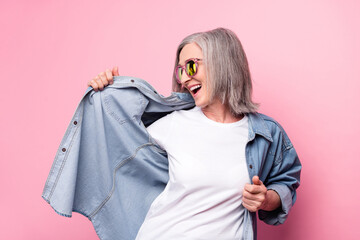 Photo of shiny adorable age woman dressed jeans outfit smiling dancing isolated pink color background