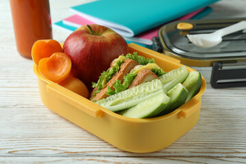 Study concept with lunch box on white wooden table