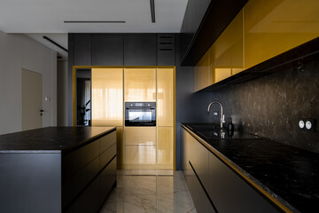 Modern black and gold kitchen with kitchen island