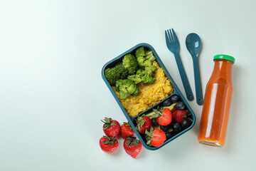 Lunch box with tasty food on white background