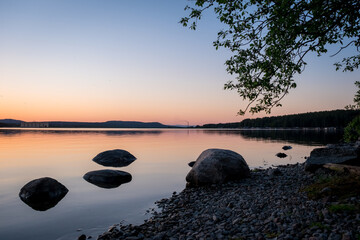 Northern landscape on the Karelian lake with stones in the foreground. Settlement Zelenoborsky,...