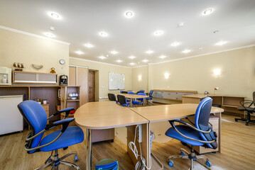Modern furnished office with office desks and chairs