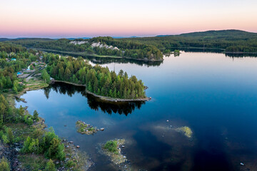 Evening panorama on Karelian lake Kovdozero. Settlement Zelenoborsky, Kandalaksha, Murmansk region, Kola Peninsula. Polar day. Karelian landscape