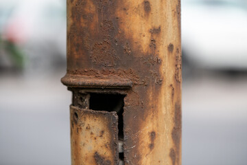 fragment of a rusty metal street lamp