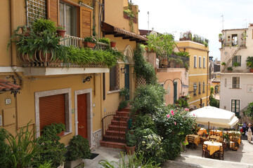 Fototapeta na wymiar Alley with restaurant in Taormina, Messina Province, Sicily, Italy.