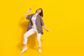 Full size photo of fancy lady dance wear eyewear shirt trousers sneakers isolated on yellow color...