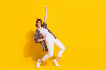 Full body photo of cool lady dance arm up wear eyewear shirt trousers sneakers isolated on yellow...