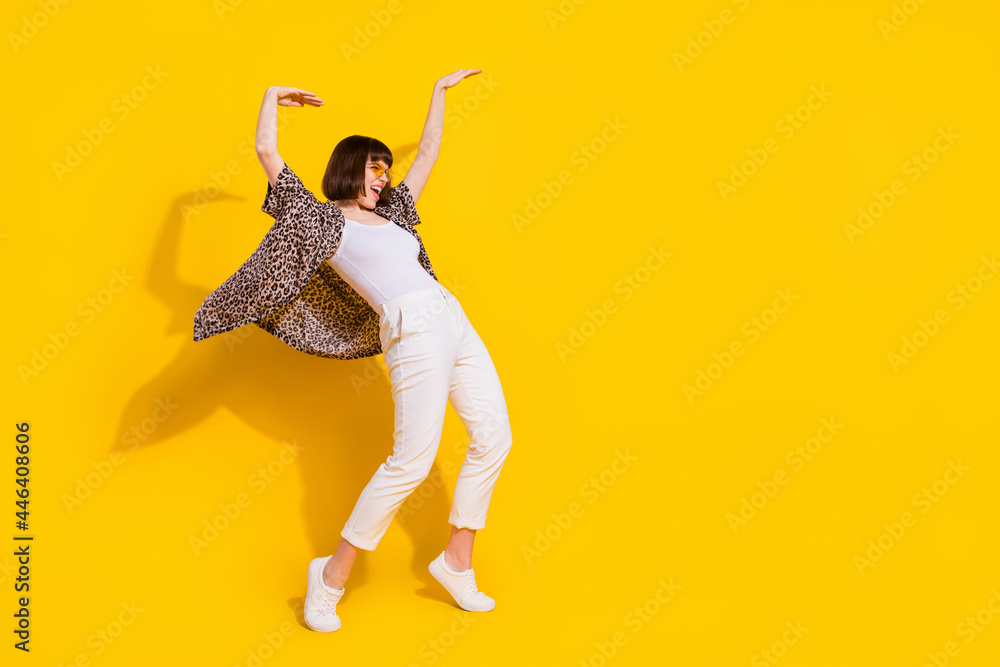 Wall mural Full size profile photo of crazy lady dance yell wear eyewear shirt trousers sneakers isolated on yellow color background