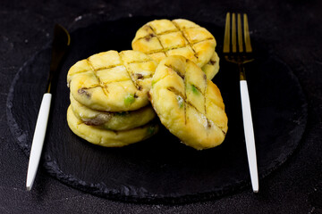 Cheesecakes on a plate of slate on a black background