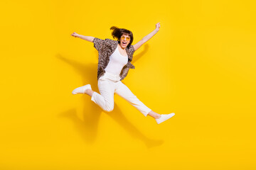Full length body size view of attractive motivated cheerful girl jumping running having fun isolated bright yellow color background