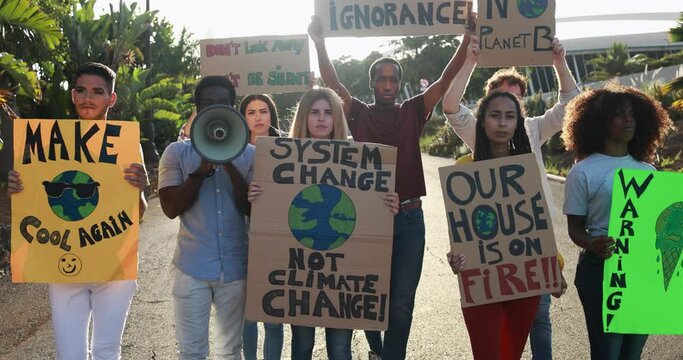Young multiracial people from different cultures with banner fighting for global climate change 