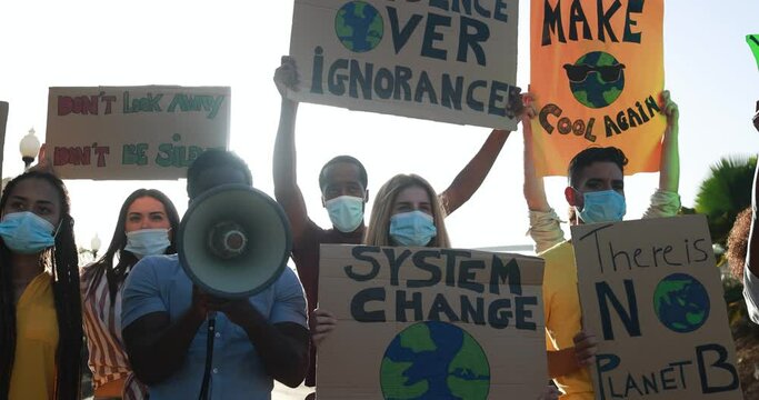 Group of demonstrators on road, young people from different culture and race fight for climate change while wearing surgical face mask - Global warming and enviroment concept
