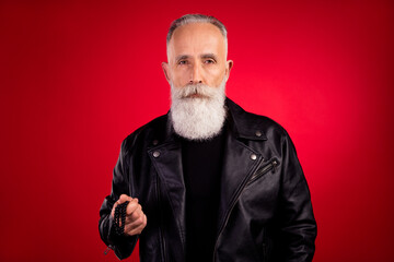 Photo of aged handsome man serious confident concentrated focused hipster isolated over red color background