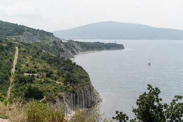 Obraz premium scenery of hills, mountains with sea and cityscape on the background
